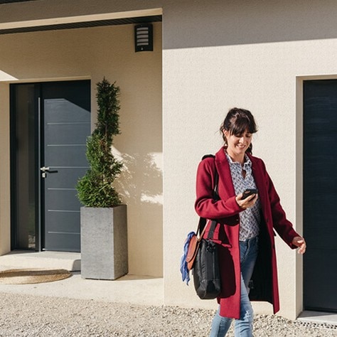 Woman in front of her house